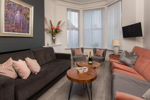 a living room with two couches and a table at 147 The Residence in Belfast