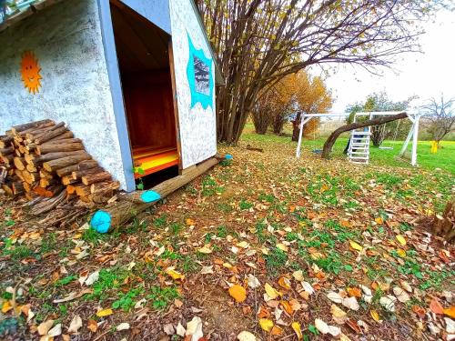 a play house with a pile of leaves on the ground at Honey hill apartment Fruska Gora in Čerević