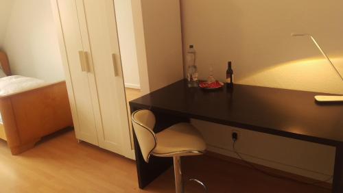 a black desk with a chair in a bedroom at Nice Private Room in Shared Apartment - 2er WG in Wiesbaden
