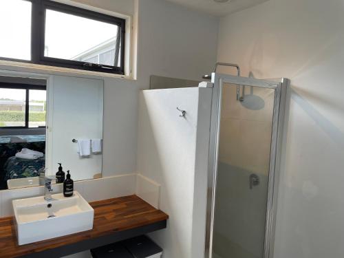 a bathroom with a sink and a shower at Kilcunda Ocean View Motel in Kilcunda