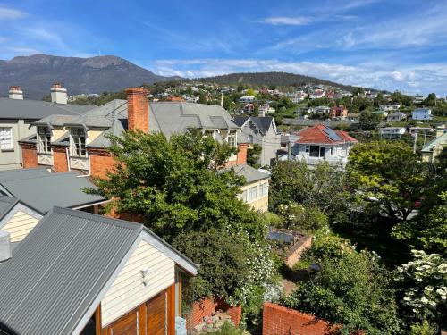 a view of a city with houses and trees at Lowena Cafe and Accommodation in Hobart
