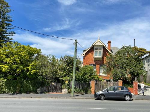 a car parked on the street in front of a house at Lowena Cafe and Accommodation in Hobart