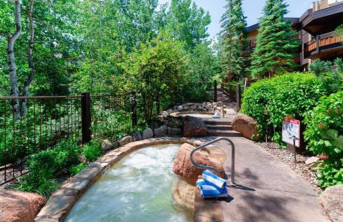 a pool in a backyard with a water slide at Laurelwood Condominiums 105 in Snowmass Village