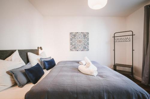 - une chambre avec un lit avec un animal rembourré dans l'établissement Sadebo Apartments Lübeck mit Terrasse oder Balkon, à Lübeck