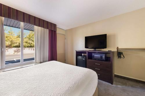 a bedroom with a bed and a flat screen tv at The Lodge at Banner Elk in Banner Elk