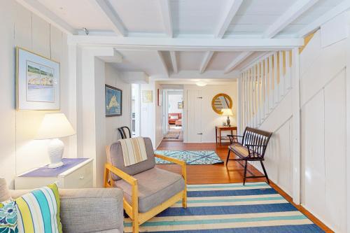 a living room with a couch and a chair at Canary Cottage in Oak Bluffs