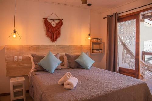 a bedroom with a bed with a stuffed animal on it at Opera Itacaré in Itacaré