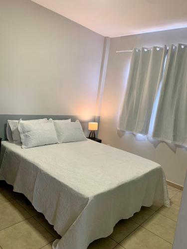 En eller flere senge i et værelse på Lindo apartamento em frente a UFOP com garagem