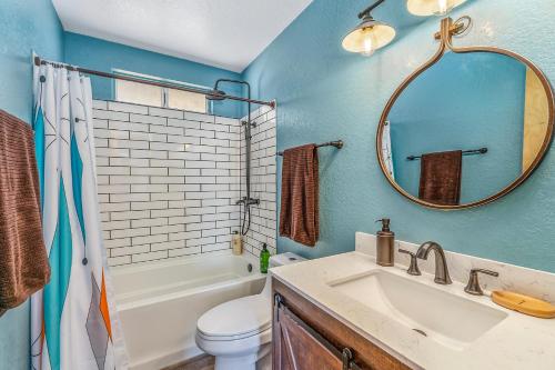 a bathroom with a sink and a toilet and a mirror at Shooting Star Lodge in Joshua Tree