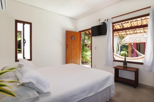 Ένα ή περισσότερα κρεβάτια σε δωμάτιο στο Villa Maravilha