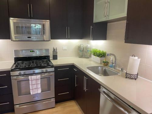 a kitchen with a stove and a sink at Super-Cute 2/2 apartment in Santa Monica with free parking in Los Angeles