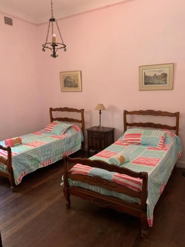 1 dormitorio con 2 camas y lámpara de araña en La Gitana en Casa Grande
