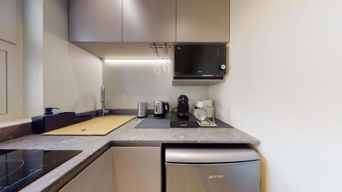 a kitchen with a counter top and a stove top oven at Carletta's Aparta-Suite & Spa in Palermo