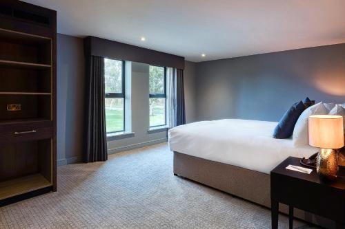 a bedroom with a large bed and a window at Aldwark Manor Estate in Aldwark