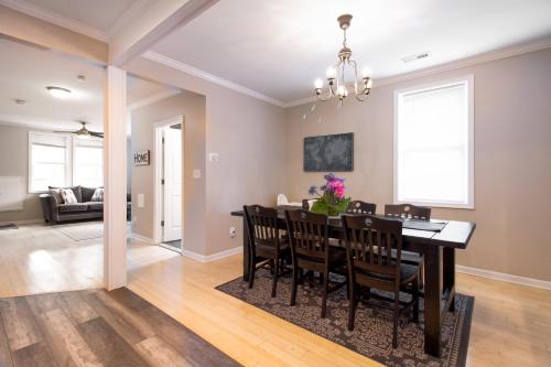 a dining room and living room with a table and chairs at The Gray Corner House by Gallaudet 3 BR 2 BA in Washington