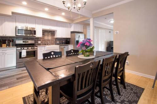 a kitchen with a dining room table and chairs at The Gray Corner House by Gallaudet 3 BR 2 BA in Washington