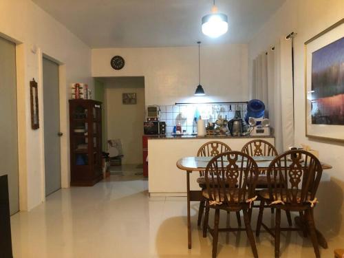 a kitchen and dining room with a table and chairs at 1 BR Staycation near Kidapawan City in Makilala