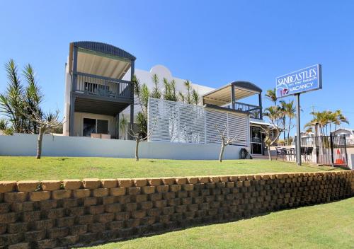 a building with a brick wall in front of it at Sandcastles 6 in Bargara