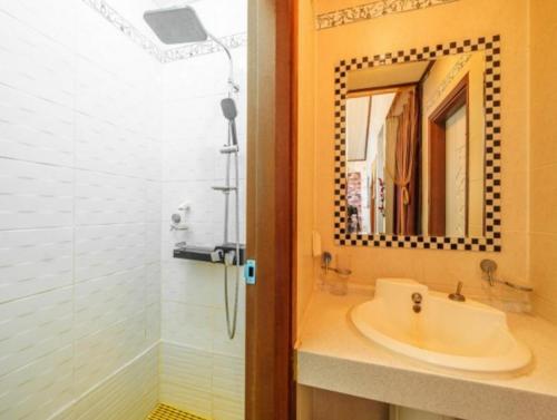 a bathroom with a sink and a mirror at Gilson Story Pension in Pyeongchang