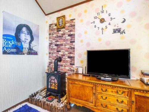 a living room with a television and a fireplace at Gilson Story Pension in Pyeongchang 