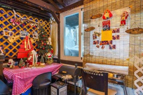 a restaurant with a table with a christmas tree on the wall at Gilson Story Pension in Pyeongchang 