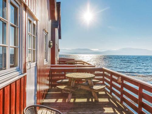 a table and chairs on a balcony overlooking the water at 6 person holiday home in Brekstad in Brekstad
