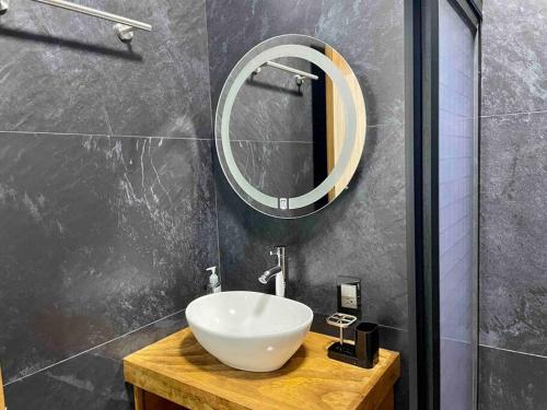 a bathroom with a white sink and a mirror at Departamento privado con estacionamiento in Tequila