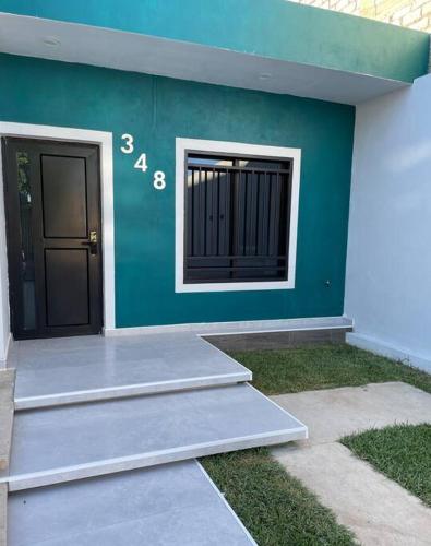 a green building with a door and a window at Departamento privado con estacionamiento in Tequila