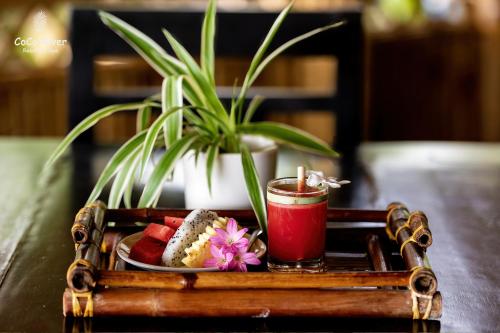 a tray of sushi and a candle on a table at Hoi An Coco River Resort & Spa in Hoi An