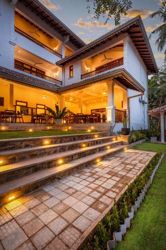 a house with stairs and lights in front of it at Serenity Boutique - Unawatuna in Unawatuna