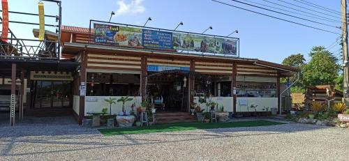 a store with a sign on top of it at Touch the Wind in Chaiyaphum