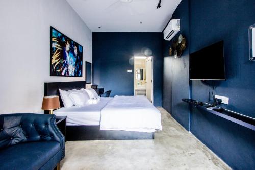 a hotel room with a bed and a couch at CITY HUNTER At Georgetown in George Town