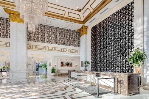 a lobby with a chandelier and a reception desk at Melia Vinpearl Quang Binh in Dong Hoi