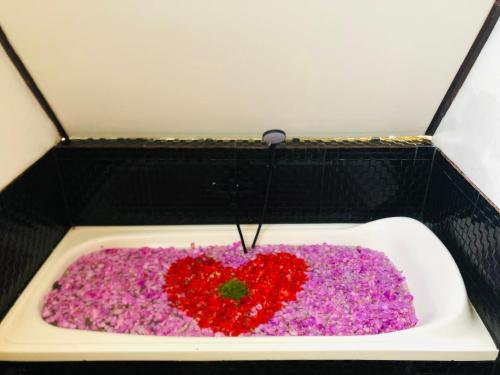 a bath tub with a heart made out of flowers at Batur Homestay and Lodge in Bangli