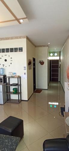 a living room with a counter and a kitchen at Touch the Wind in Chaiyaphum