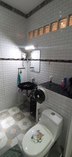 a bathroom with a toilet with a picture on it at Touch the Wind in Chaiyaphum