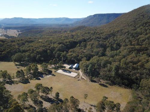 an aerial view of a house in the middle of a forest at Hidden Gem, Megalong Valley, Blue Mountains in Kanimbla