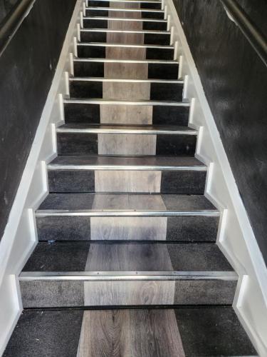 a set of stairs with wooden floors in a building at The Entrance Backpackers in The Entrance