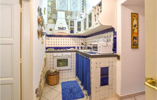 a small kitchen with blue and white tiles at Sicily Love Loft in Catania