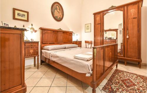 a bedroom with a wooden bed and a mirror at Sicily Love Loft in Catania