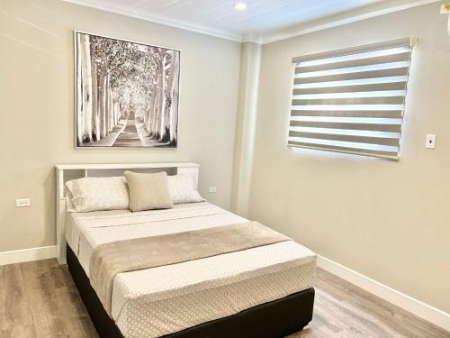 a bedroom with a bed and a painting on the wall at SHAK Condos- Luxury, Functionality and Comfort in Saint Helena
