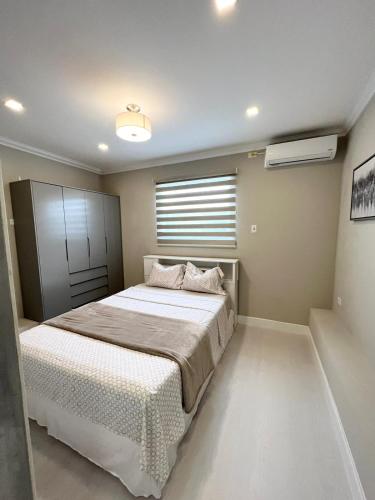 a bedroom with a large bed and a window at SHAK Condos- Luxury, Functionality and Comfort in Saint Helena