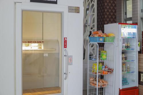 an open door to a refrigerator in a store at RedDoorz Syariah @ Klojen Malang in Malang