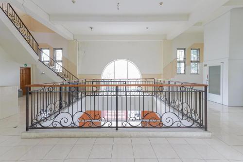 a staircase with a iron gate in a room at RedDoorz Syariah @ Klojen Malang in Malang