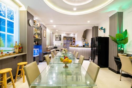 a dining room with a long table and chairs at Rosa Hotel & Spa in Ho Chi Minh City