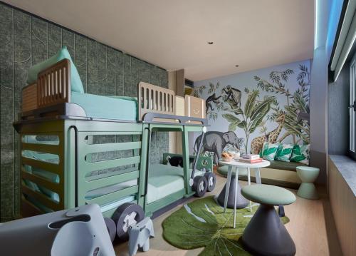a childs bedroom with a bunk bed and a table at PARKROYAL COLLECTION Kuala Lumpur in Kuala Lumpur