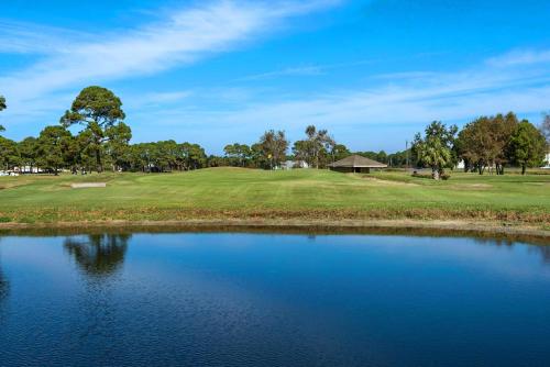 a view of a golf course with a pond at Ariel Dunes II 101 in Destin