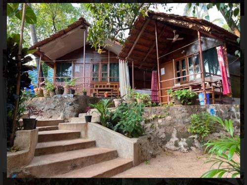 a house with stairs in front of it at SHIV SAI HUTS in Canacona