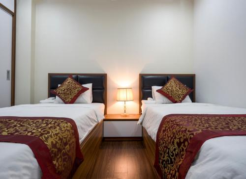 Giường trong phòng chung tại *Ha Long Homestay @ Sunrise Apartment - 2 BR