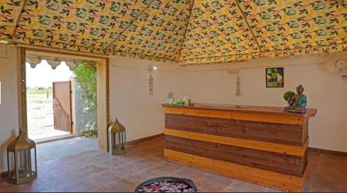 a living room with a ceiling with a patterned ceiling at Sunny Desert Camp in Kūri